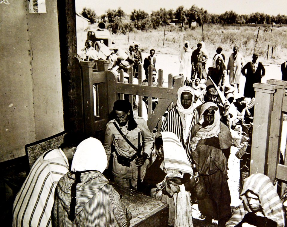Women pay at the desk while entering market in Tunisia 1943 (35486768225)