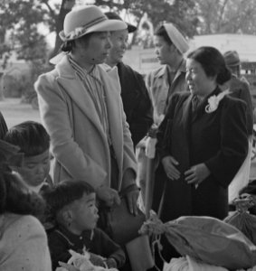 Woodland, California. Families of Japanese ancestry with their baggage at railroad station awaiting . . . - NARA - 537803 (cropped) photo