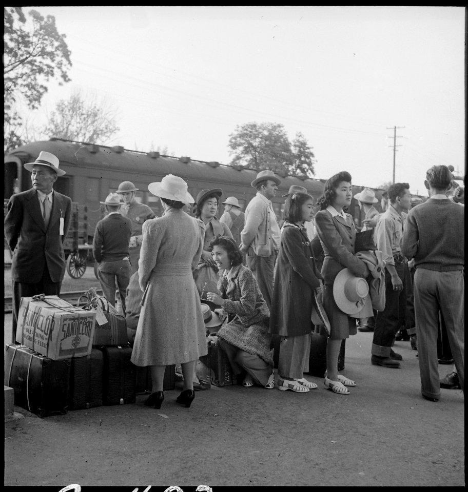 Woodland, California. Families of Japanese ancestry with their baggage at the railroad station wait . . . - NARA - 537805
