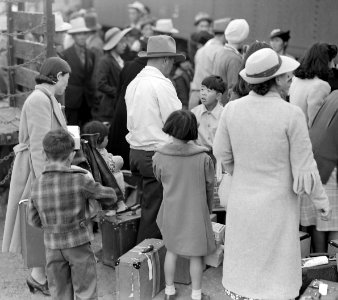 Woodland, California. Farm families of Japanese ancestry waiting at the railroad station for the sp . . . - NARA - 537809 (cropped) photo