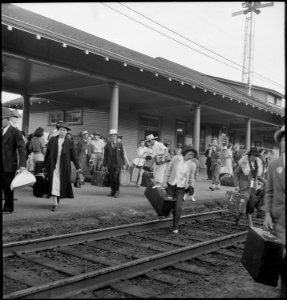 Woodland, California. Families of Japanese ancestry leave the station platform to board the train f . . . - NARA - 537811 photo