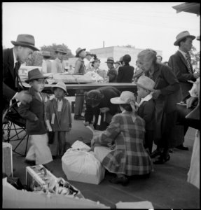 Woodland, California. Families of Japanese ancestry with their baggage at railroad station awaiting . . . - NARA - 537806 photo