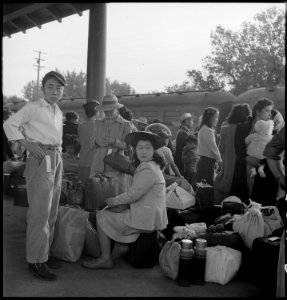 Woodland, California. Families of Japanese ancestry with their baggage at railroad station awaiting . . . - NARA - 537804 photo