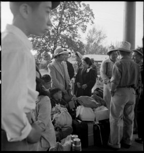 Woodland, California. Families of Japanese ancestry with their baggage at railroad station awaiting . . . - NARA - 537803 photo