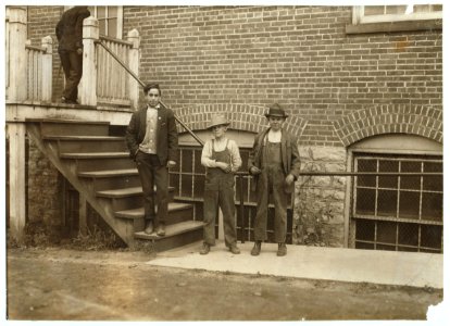 Workers in Fargo & Phelps Shoe Co., saw six boys and two girls probably under 14. Large sign up, 'Boys wanted.' LOC nclc.04709