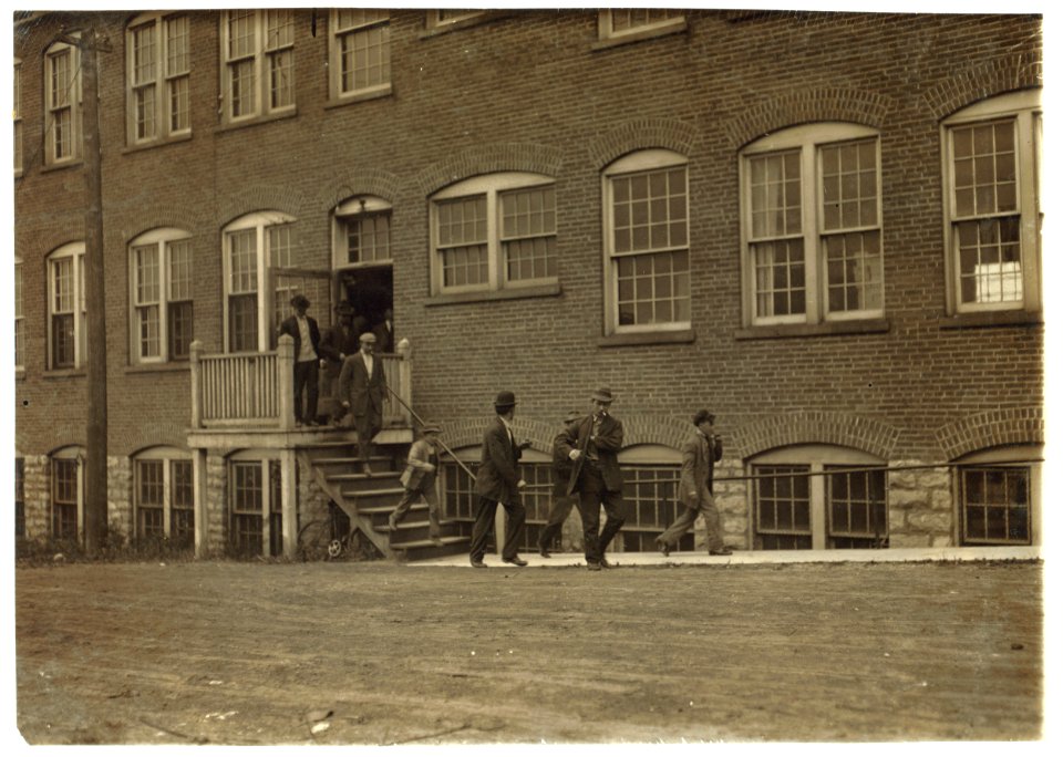 Workers in Fargo & Phelps Shoe Co., saw six boys and two girls probably under 14. Large sign up, 'Boys Wanted.' LOC nclc.04710