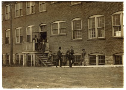 Workers in Fargo & Phelps Shoe Co., saw six boys and two girls probably under 14. Large sign up, 'Boys Wanted.' LOC nclc.04710