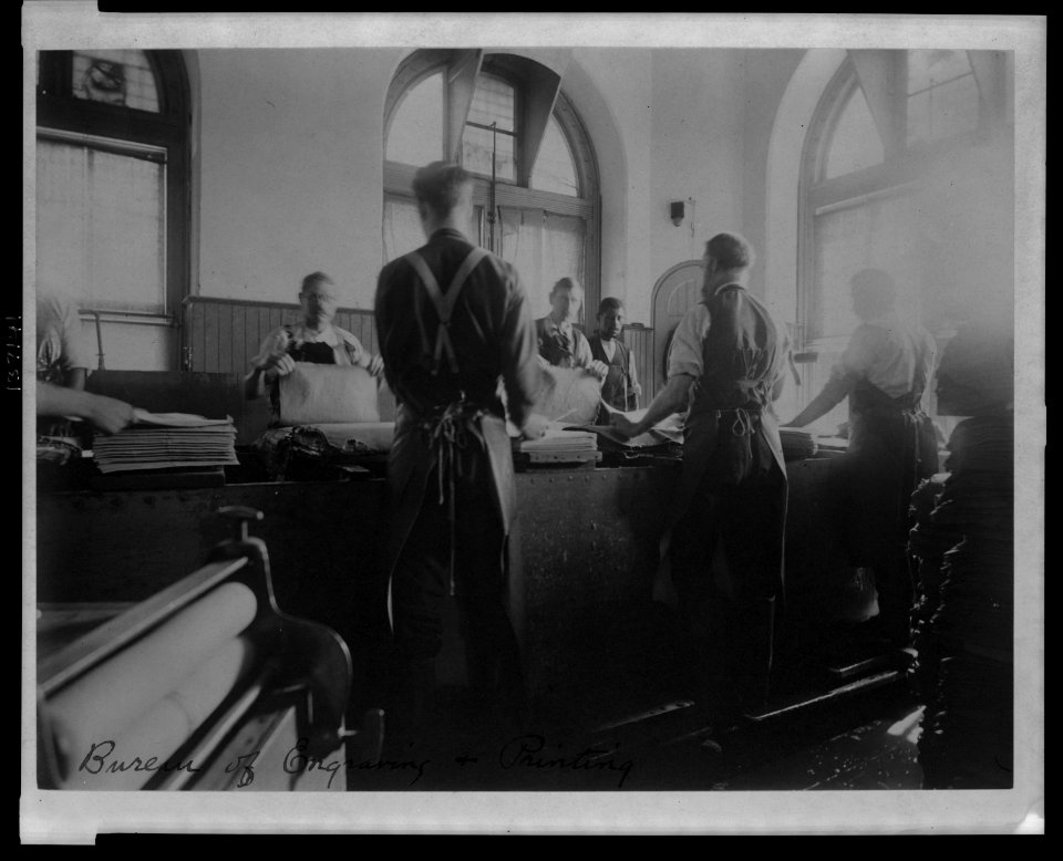 Workers wetting sheets prior to printing paper money at the Bureau of Engraving & Printing LCCN2006692526