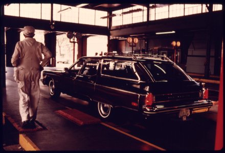 Workman Follows His Station Wagon During Testing at an Auto Emission Inspection Station in Downtown Cincinnati, Ohio...09-1975 (4265793749)