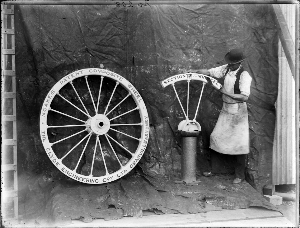 Workman posed with Noakes patent composite wheel, from The Powerhouse Museum
