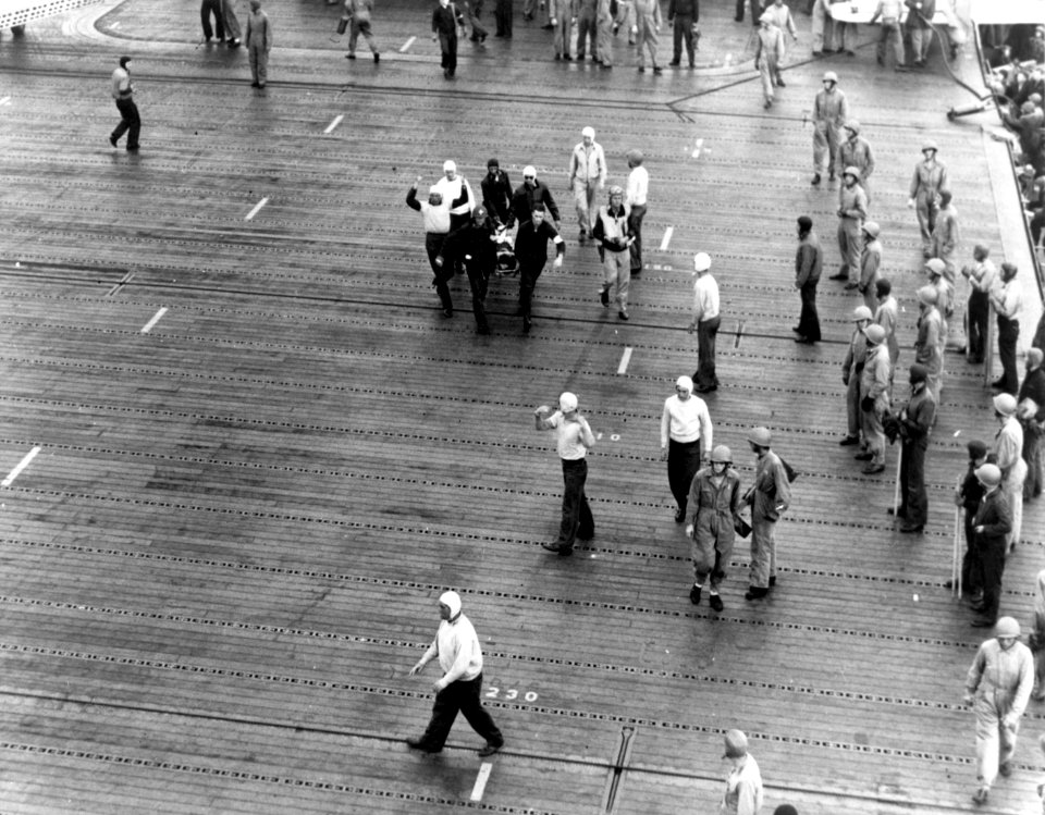 Wounded airman is carried across the flight deck of USS Enterprise (CV-6), 4 June 1942 (80-G-7746)
