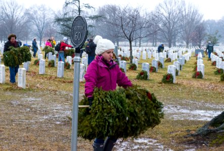 Wreath cleanup event, Girl carrying wreaths in Section 60 (16168057328) photo