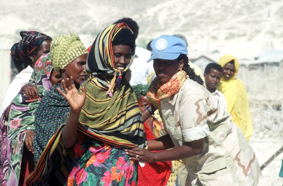 Yasmin Said, an interpretor for the US Army Criminal Investigation Division frisks Somali women before they're seen by the 46th Medical Task Force doctors DF-ST-96-01387