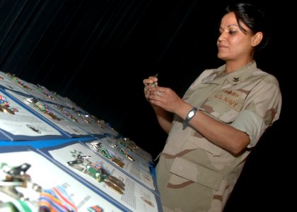 Yeoman 1st Class Raafia Ali prepares 37 medals and ribbons 2010 photo