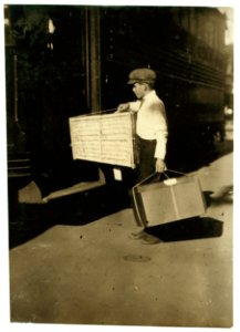 Young delivery boy with heavy bundles. LOC nclc.03953 photo