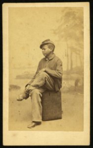 Young African American boy sitting on a case) - photographed by Black LCCN2010647702