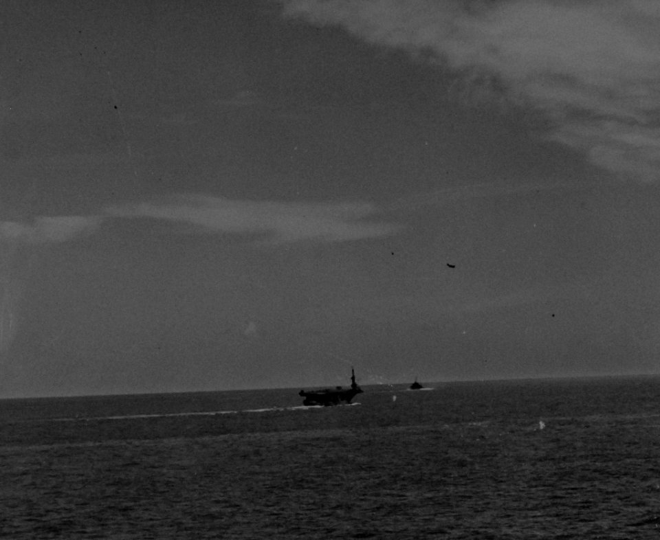 Yokosuka D4Y Judy dive bomber misses the USS Petrof Bay (CVE-80) with its bomb 25 October 1944