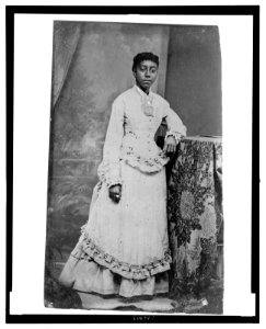 Young African American woman, standing with one arm resting on a table LCCN2006688029 photo