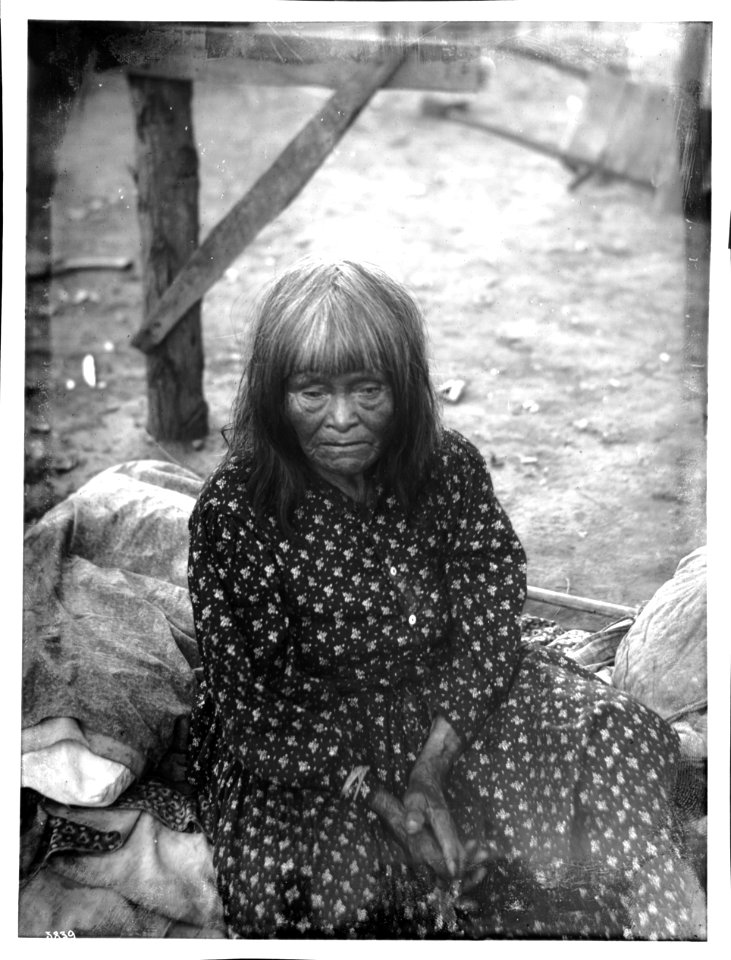 Yokut Indian woman sitting outside, Tule River Reservation near Porterville, California, ca.1900 (CHS-3839)