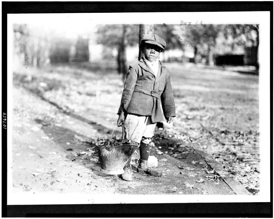 Young boy carrying a bucket of coal, Washington, D.C. or New York City LCCN93507056