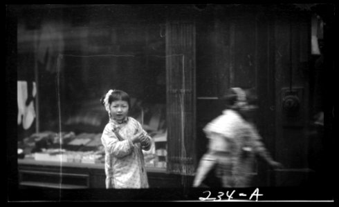 Young girl walking down the street, looking into the camera, Chinatown, San Francisco LOC agc.7a09015