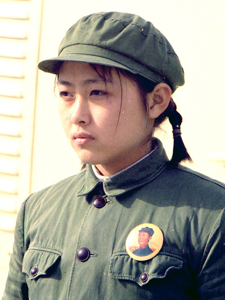 Young girl dressed in soldier attire at the arrival of the press plane in Peking, China - NARA - 194411 (cropped)