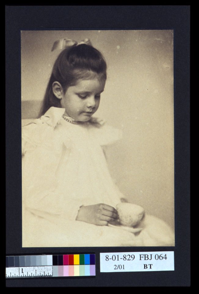 Young girl in white dress, seated holding teacup and saucer) - A.P LCCN2004676287