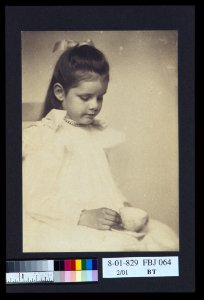Young girl in white dress, seated holding teacup and saucer) - A.P LCCN2004676287 photo
