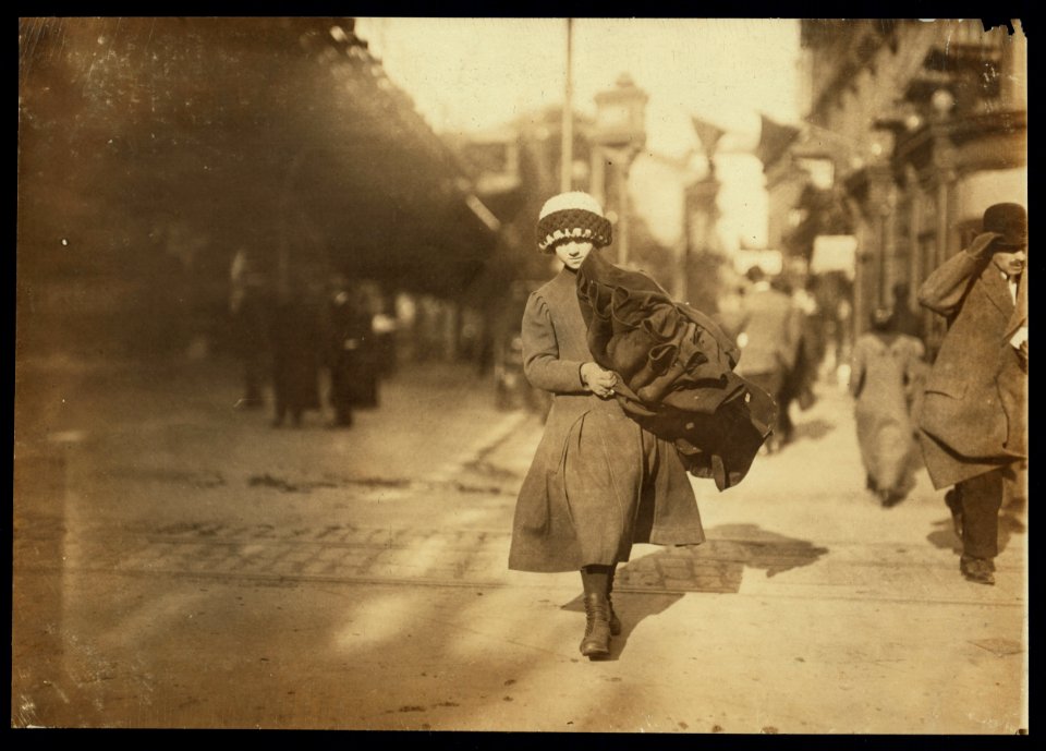 Young girl carrying bundle of coats home to be finished. Near Astor Place, N.Y. LOC cph.3b01101