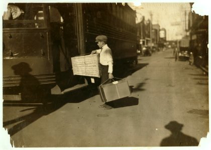 Young delivery boy with heavy bundles. LOC nclc.03952 photo