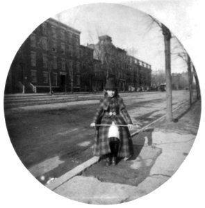 Young girl wearing riding clothes, with crop, on Washington, D.C., street LCCN2004677390