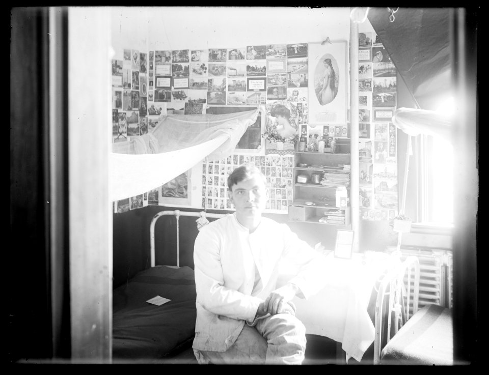 Young man in dormitory room LCCN2016824419