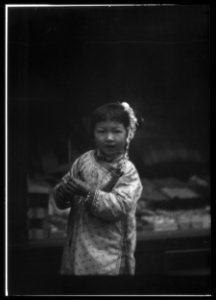 Young girl walking down the street, looking into the camera, Chinatown, San Francisco LOC agc.7a55027