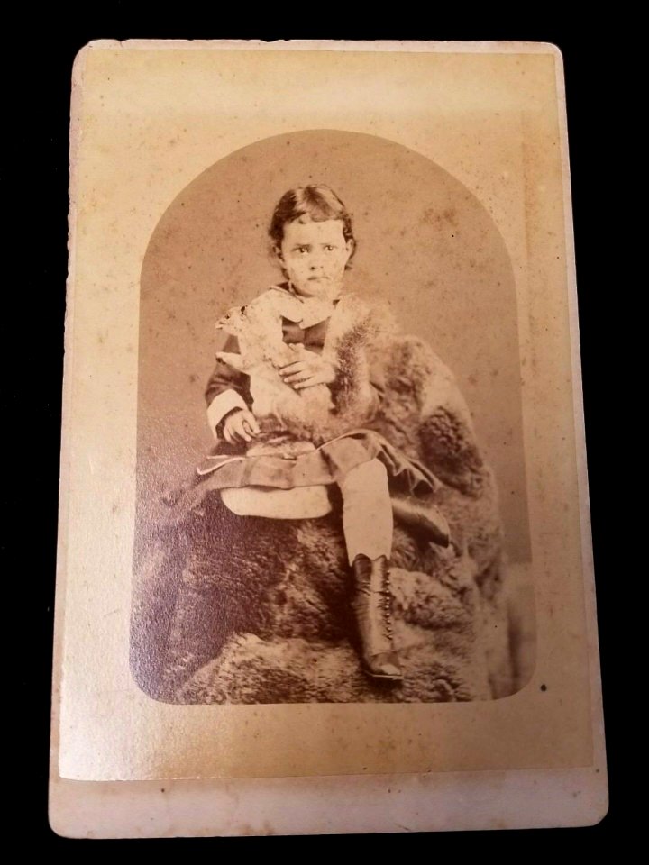 Young Kaiulani with squirrel in lap, photograph by A. A. Montano, cabinet photograph