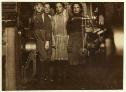 Young spinners and doffers in Richmond Spinning Mills, taken during working hours. Smallest girl said she had been working there for months. The other girl said she didn't know how long. LOC nclc.01966