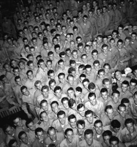 Young men training at pre-flight school at Del Monte Hotel, Del Monte, Calif., grin as they file out of the mess hall. - NARA - 520807 (cropped) photo