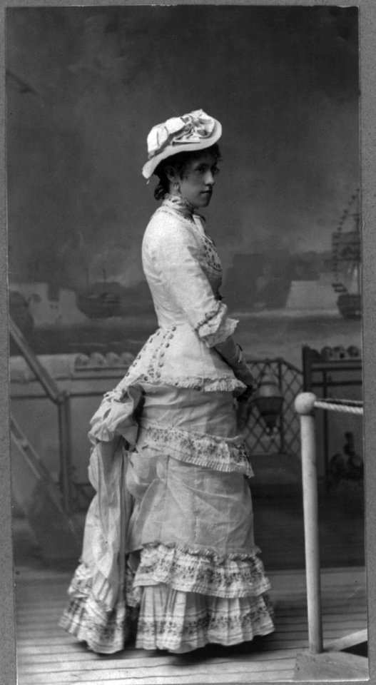 Young woman of the cast of Gilbert & Sullivan's H.M.S. Pinafore, posed against a painted backdrop LCCN2000569680