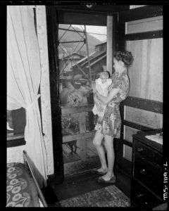 Young mother and baby who live in company housing project. Note view through door. Kingston Pocahontas Coal Company... - NARA - 540675