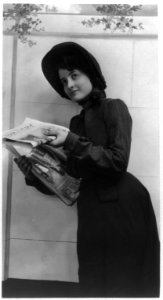 Young woman modeling- distributing copies of Salvation Army newspaper, War Cry LCCN2003677246