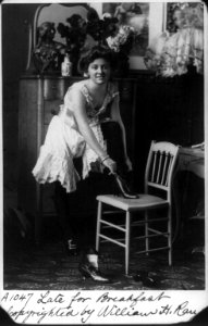 Young woman in glamourous, erotic poses- Late for Breakfast - in negligee, putting on high-button shoes LCCN2005688908