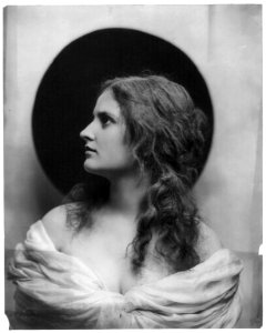 Young woman modeling- head and shoulders, facing left, wearing low-cut dress LCCN2003677214