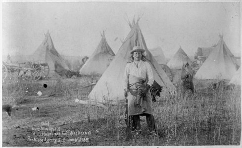 Young-Man-Afraid-of-His-Horses (Tashun-Kakokipa), an Oglala Sioux, standing in front of his lodge, Pine Ridge, South Dak - NARA - 530813 photo