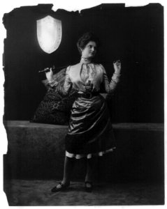 Young women modeling- full lgth., holding sword behind shoulders LCCN2003677224
