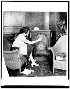 Young woman tuning a radio LCCN93508126