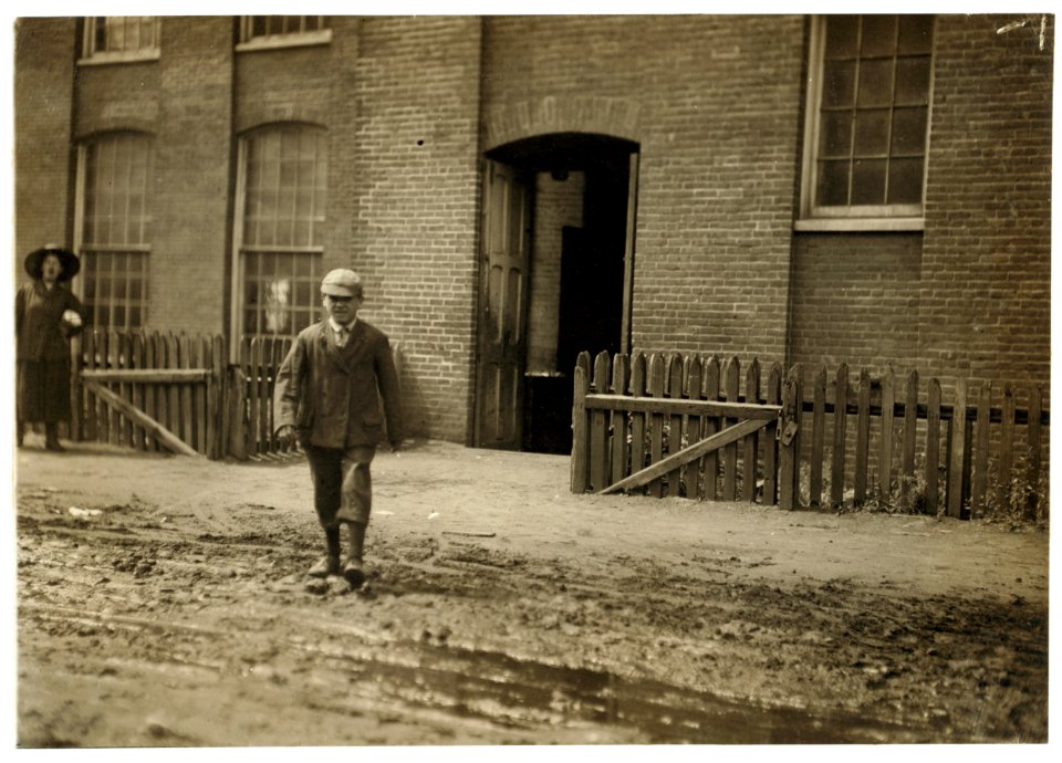 Young worker leaving mill of Sagamore Manufacturing Company, Fall River, Mass., August 26, 1911. Noon. Richard K. Conant, Witness. LOC nclc.02255