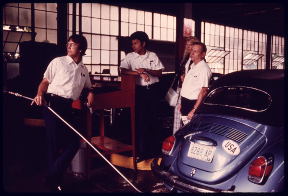 Young Woman Watches an Exhaust Analyzer Machine as Her Auto Is Being Tested at an Auto Emission Inspection Station in Downtown Cincinnati, Ohio...09-1975 (4265798515)