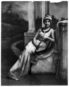 Young women modeling- Full lgth., seated, holding lyre LCCN2003677238
