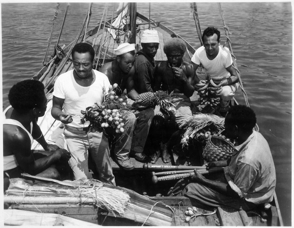 34th CB's trading with natives from Malaita. Left to right, native, Percy J. Hope, MS2c, Lilton T. Walker, S1c, two nat - NARA - 520630