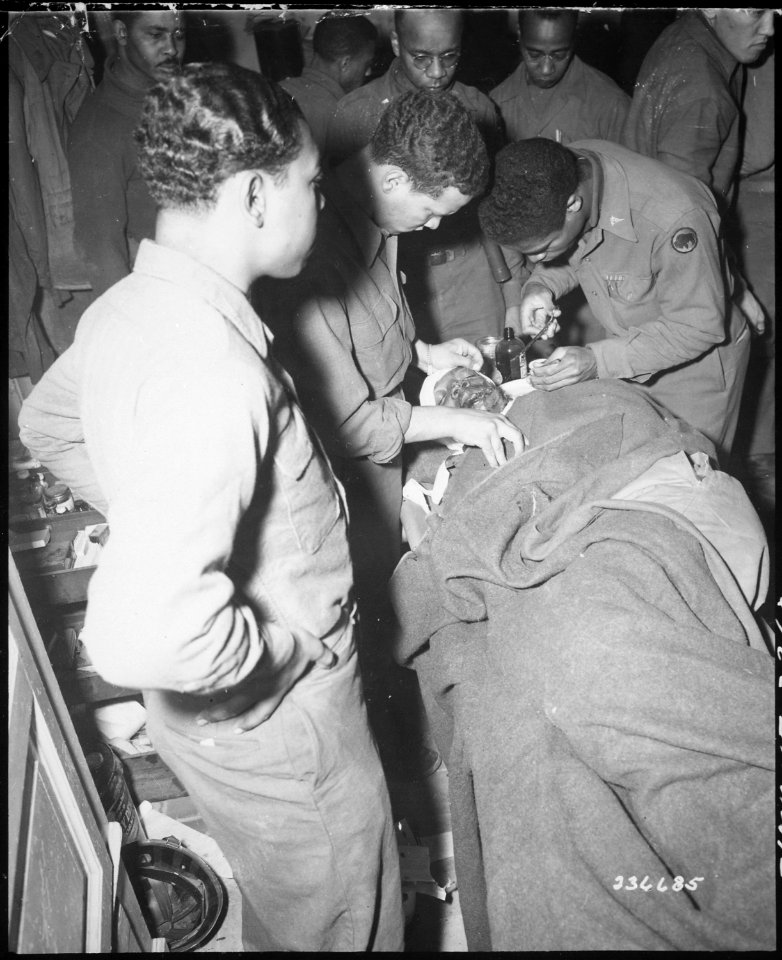 Capt. Ezekia Smith, 370th Inf. Regt., 92nd Div., receives treatment at the 317th Collecting Station, for shell fragment - NARA - 531332