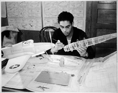 Carlton J. Dearborn, S2c (cements a stringer on the fuselage of balsam model of Stuka Dive Bomber at Camp Smalls, U.S. - NARA - 520667